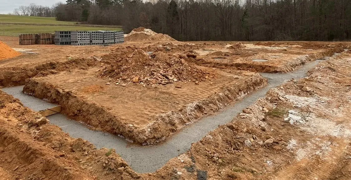 Skid steer clearing debris on a demolition site in Cleveland County